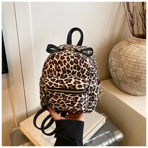 Detail of leopard print mini backpack with golden zippers and a black decorative bow