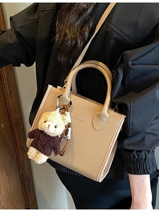 Retro beige leather bucket bag with top handle and cute teddy bear charm accessory