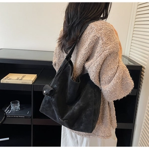 Detail view of black matte tote bag with Essential Katie Fashion logo in minimalist style