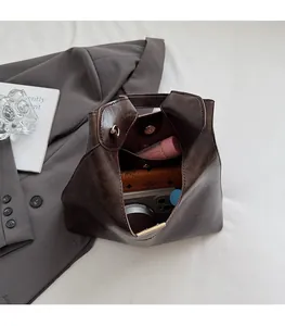 Top view of large brown vintage tote bag showing spacious interior with essentials