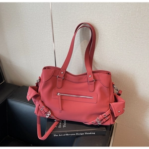 Detailed view of deep coral pink matte tote bag with punk style buckles and side pockets