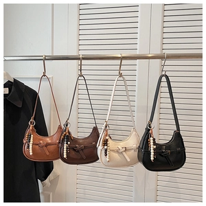 Detail of four hobo bags in tan, brown, cream, and black with beaded charms
