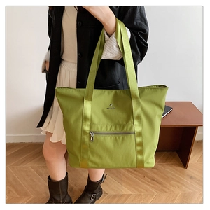 Vue détaillée du cabas Oxford vert olive montrant les sangles et la poche zippée avant