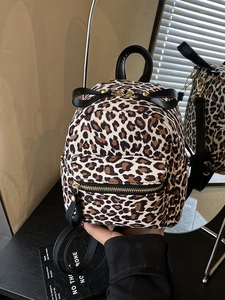 Stylish leopard print mini backpack with black bows and adjustable leather-style straps