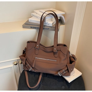 Detail view of large brown tote bag showing the soft PU leather and silver buckle hardware