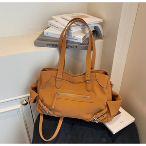 Detail view of the vintage ginger yellow tote bag with metallic zippers and textured PU leather
