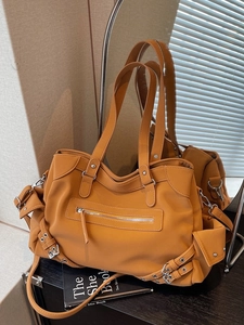 Vintage ginger yellow large capacity tote bag with adjustable straps on a wooden table