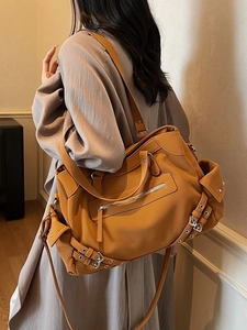 Retro mustard yellow leather tote bag with decorative buckles and crossbody strap