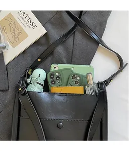 Interior storage view of a black faux leather crossbody bag showing large capacity space