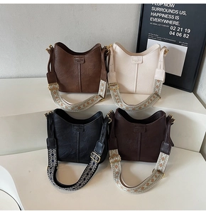 Detail view of stylish bucket bags in four colors with retro woven wide straps