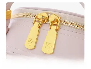Detailed macro shot of smooth golden dual zippers on lavender embroidered handbag
