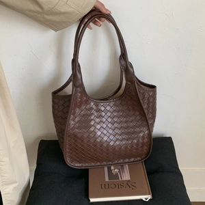 Detailed view of brown woven tote bag handle and large capacity braided structure