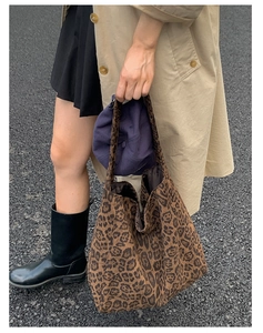 Detail of soft leopard print tote bag with spacious interior and suede texture finish