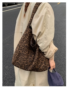 Street style shot of large leopard print canvas tote bag on a beige trench coat