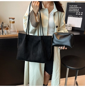 Detail of black faux suede tote bag and matching zipper pouch set for women