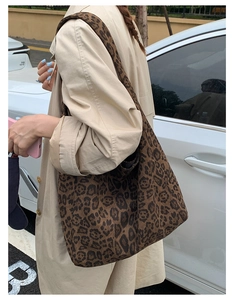 Detail of leopard print canvas hobo bag on shoulder for casual autumn style