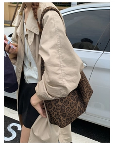 Close-up of leopard print tote bag styled with a beige trench coat for autumn fashion