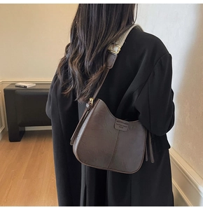 Detail view of dark coffee hobo bag with textured leather and dual strap styles