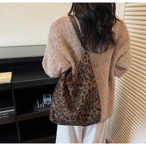 Detailed view of the leopard print bucket bag texture and retro shoulder strap