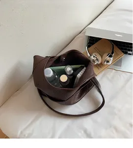 Top view of deep brown pebbled leather bucket bag showing spacious interior capacity