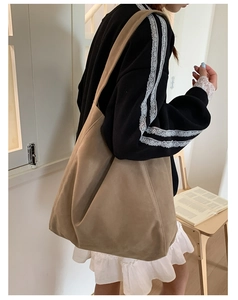 Brown faux suede tote bag shown on model highlighting spacious capacity and casual style