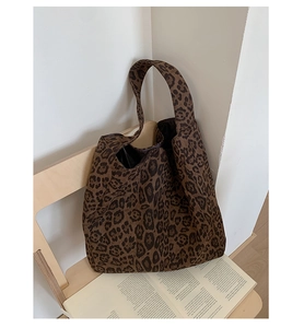Detail shot of the soft leopard print fabric and wide shoulder strap on this tote bag