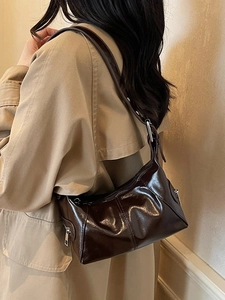 Deep brown patent leather hobo bag with glossy finish and decorative stitching for women