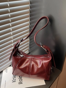 Chic burgundy patent leather hobo bag with star zipper detail and pleated texture