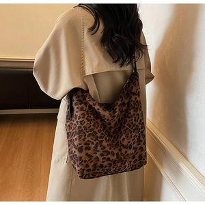 Detail of leopard print tote bag showing large capacity and black slim shoulder straps