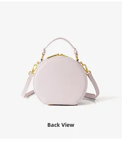 Back view of lavender round crossbody bag with leather texture and gold hardware