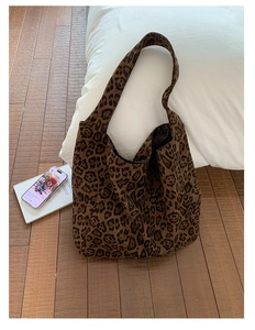 Detail of the leopard print canvas tote bag showing the soft texture and wide shoulder strap