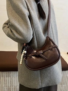 Minimalist dark brown half-moon crossbody bag with vintage knotted strap and beads