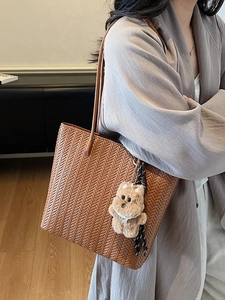 Brown woven tote bag with V-shaped texture and plush puppy charm for women daily commute