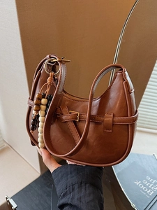 Retro brown leather hobo bag with decorative metal buckle and beaded charm for women