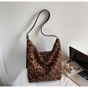 Detail of leopard print hobo bag with black leather shoulder strap and metal buckle