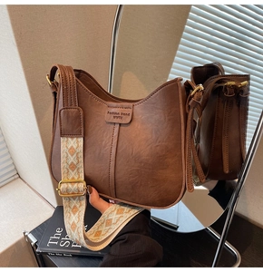 Détail du sac à bandoulière marron vintage en cuir PU avec sangle jacquard et logo WWTU
