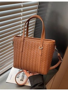 Vintage brown woven leather bucket bag with top handles and adjustable shoulder strap