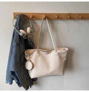 Detail of cream large tote bag with textured PU leather and matching coin purse charm