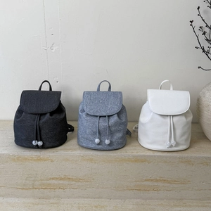 Minimalist retro drawstring backpacks in charcoal, grey, and cream faux leather finish