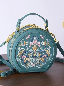 Elegant teal embroidery round bag with floral pattern and adjustable strap crossbody