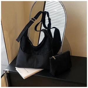 Dettaglio della borsa tote in pelle scamosciata nera opaca con pochette e fibbie dorate