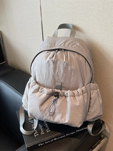 Minimalist lavender nylon backpack with drawstring pocket and durable gray straps