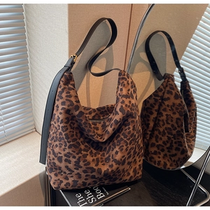 Close-up of leopard print hobo bucket bag showing premium texture and leather strap