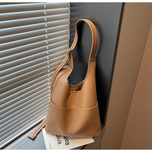 Detailed view of caramel hobo bag with litchi texture and adjustable shoulder strap