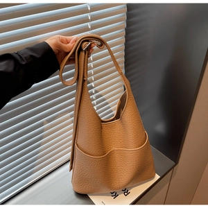 Detailed view of the khaki pebbled leather hobo bag with two large functional front pockets