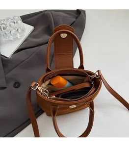 Spacious interior of brown matte suede bucket bag with organized daily essentials
