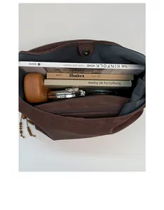 Spacious interior of a brown faux leather tote bag with a functional zipper pocket