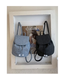 Minimalist mini backpacks in gray and black with drawstring closure and bead detail