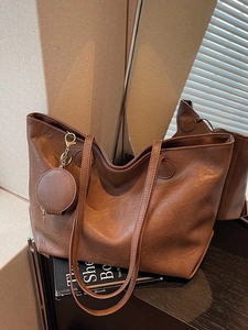 Brown large capacity tote bag with small round pouch and dual shoulder straps
