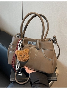 Vintage khaki brown faux leather tote bag with contrast stitching and bear charm